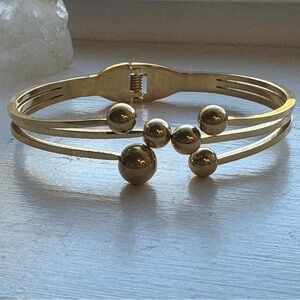 Gold Tone Beaded Bangle. 6 1/2” opens in front of